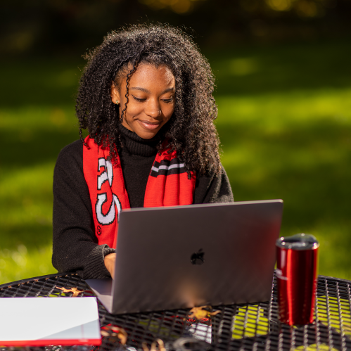 Student sitting at outdoor table