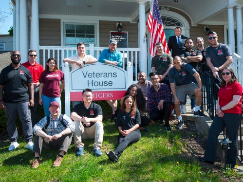 military veteran students in front of the veteran house